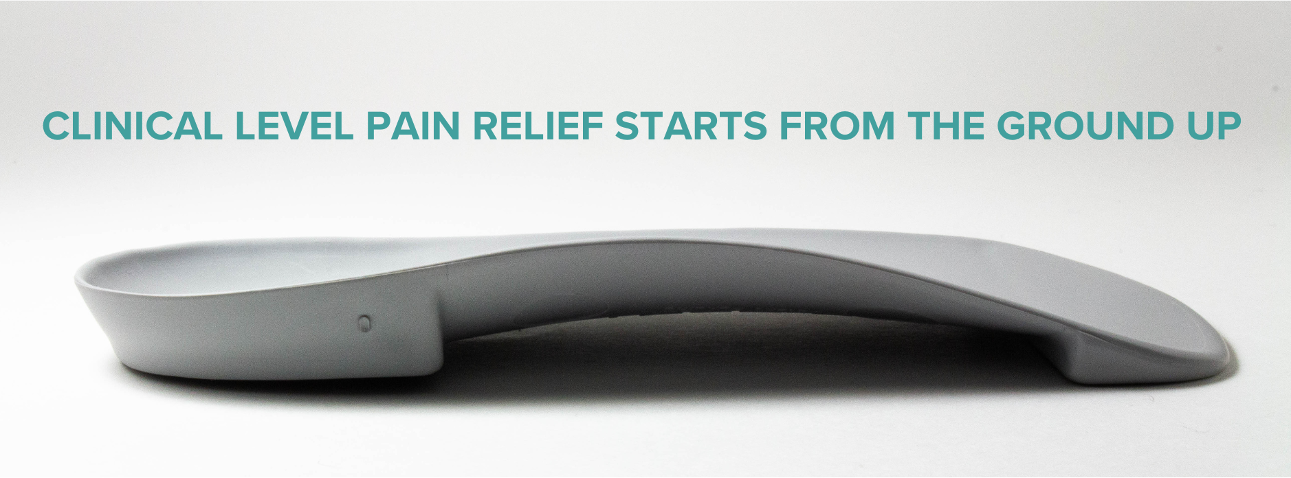 Gray orthopedic shoe insert with text about clinical level pain relief and design by a podiatrist.